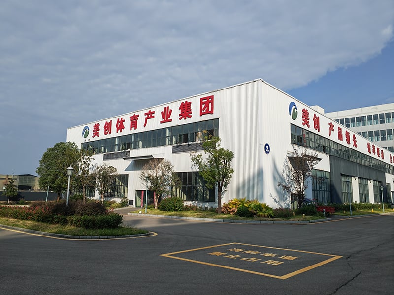 MCG white factory building exterior with landscaped entrance
