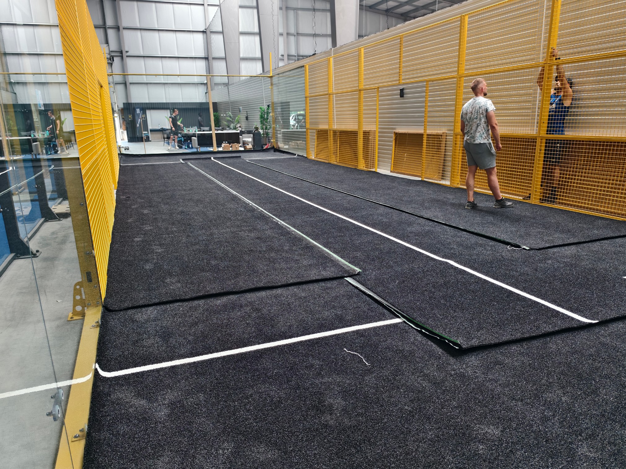 Lawn laying - black artificial turf with white markings