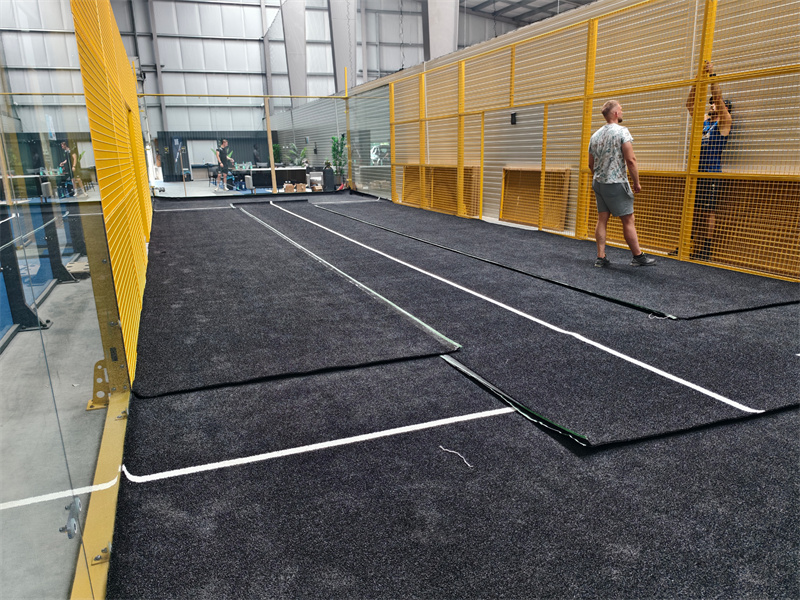 Lawn laying - black artificial turf with white markings