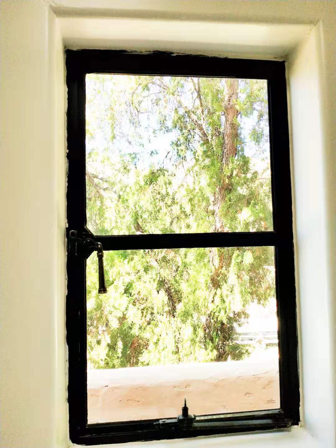 What are the durability benefits of a stainless steel window in coastal areas?