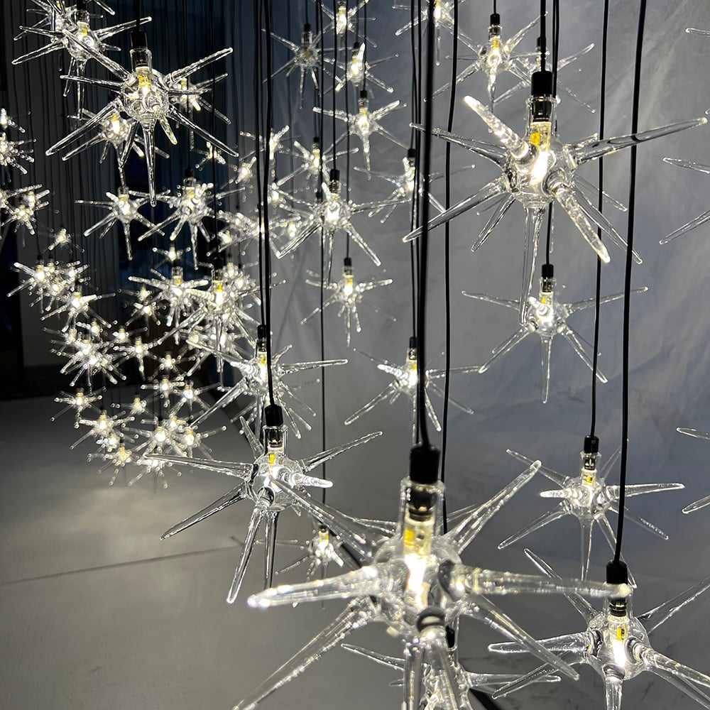 Pruebas en fábrica de una araña de cristal soplada a mano personalizada con forma de estrella para un proyecto canadiense