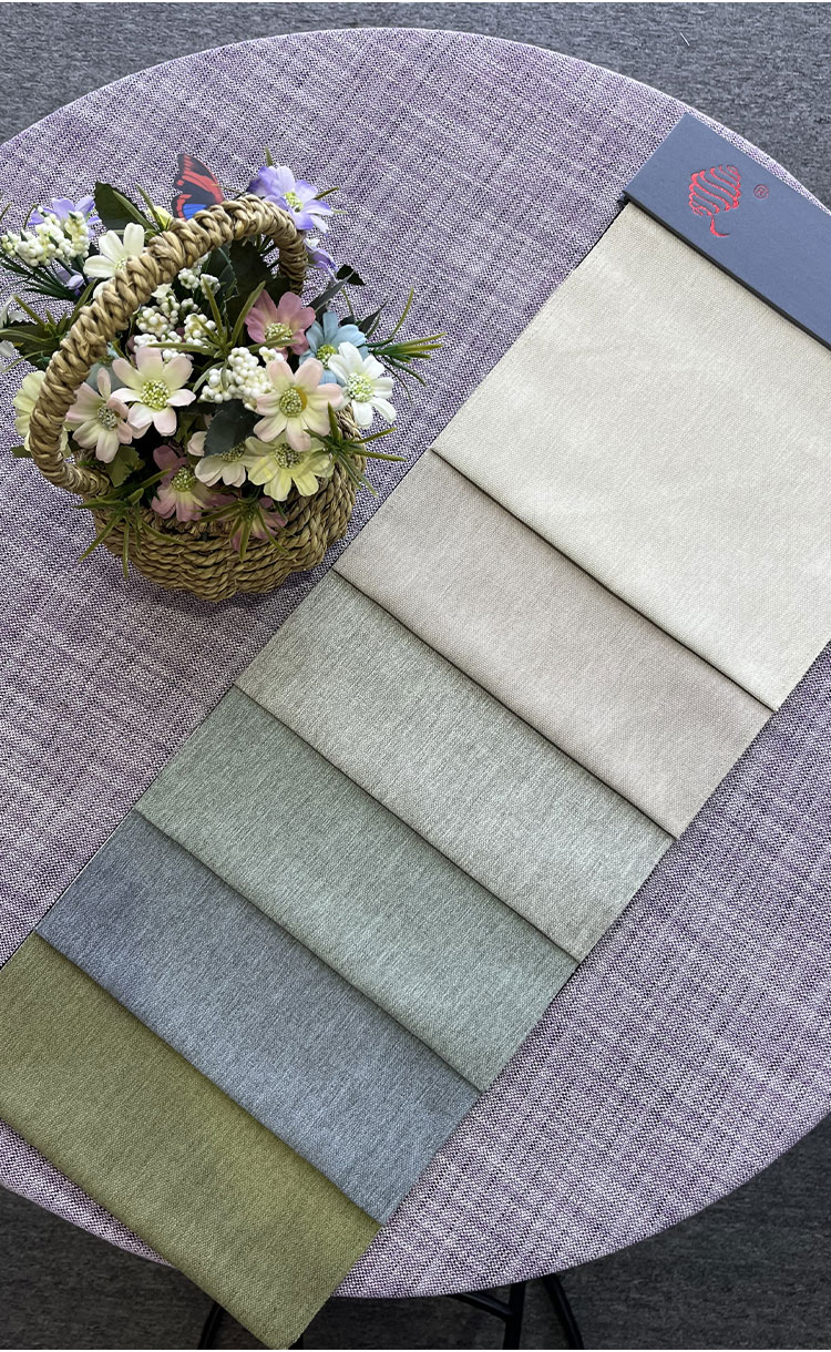 QSF color card swatches of linen-look draping oxford fabric in neutral and earthy shades on a round table beside a flower basket.