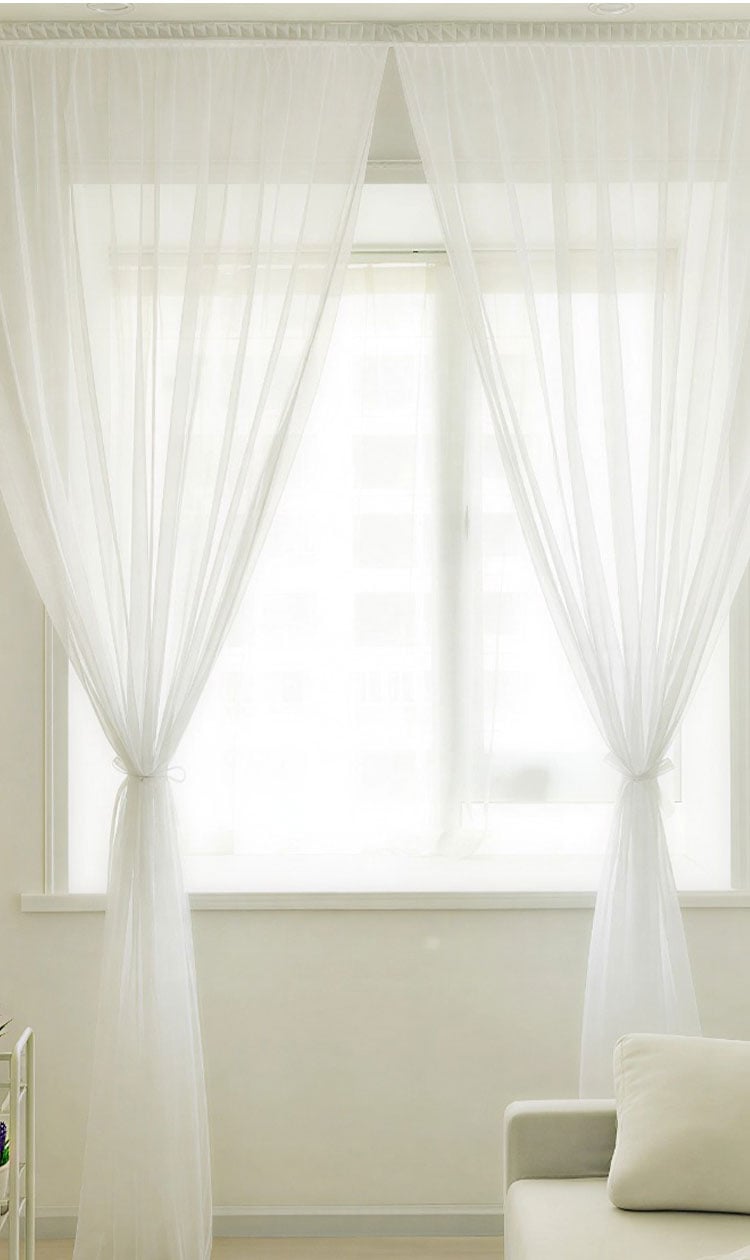 Floor-to-ceiling white sheer curtains filtering daylight, showcasing soft drape and translucent look
