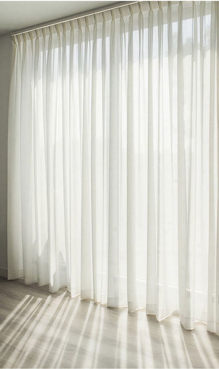 Full-length Doris textured sheer curtains in minimalist living space, softly diffusing natural light for an airy, elegant atmosphere.