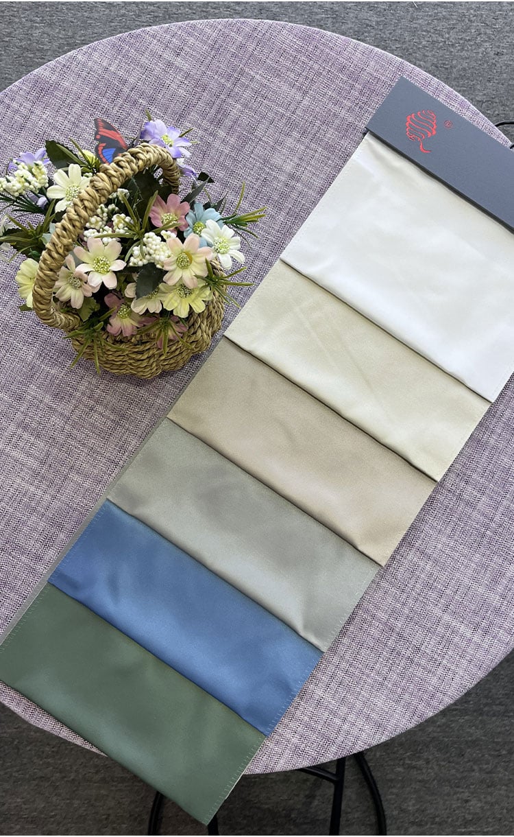 Satin curtain fabric color swatches display—white, beige, gray, blue and green samples for matching