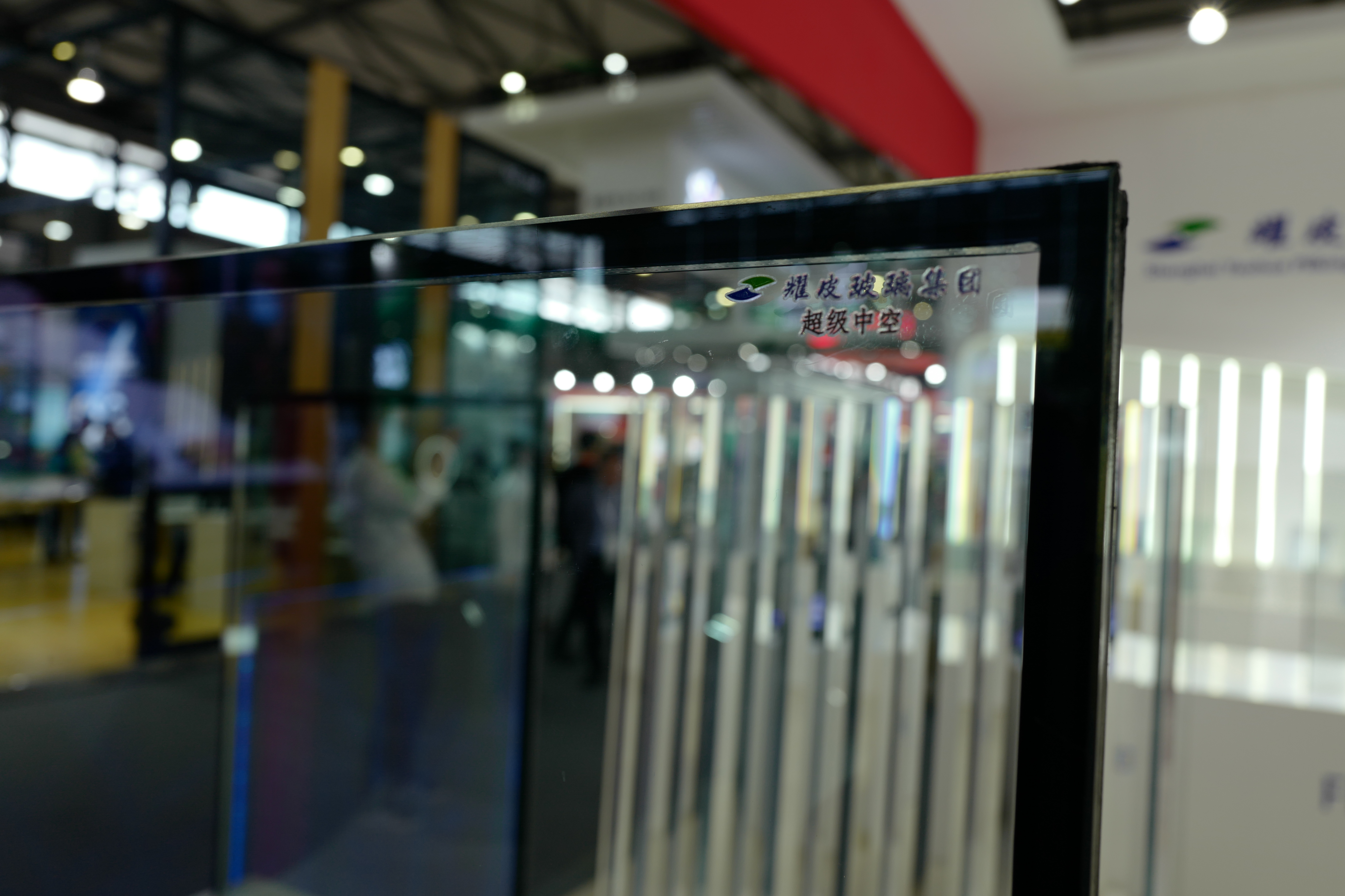 What are the benefits of using patterned glass for privacy in buildings?