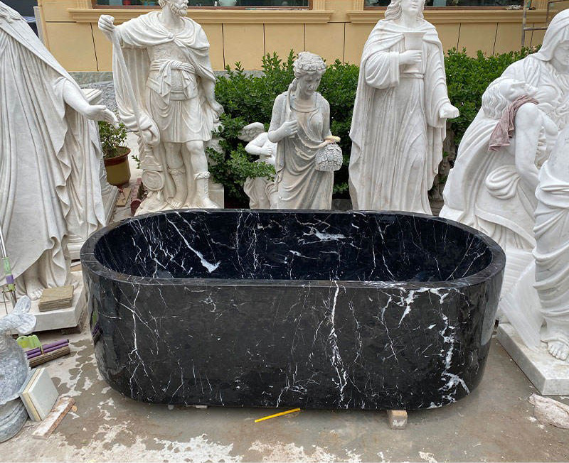 Black natural stone freestanding bathtub with white marble veining
