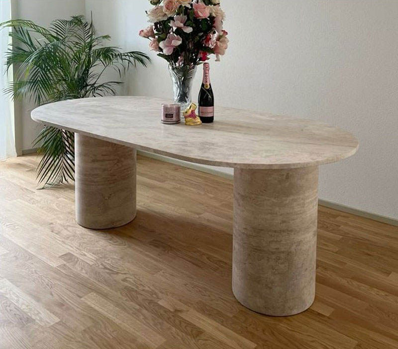 Vintage travertine dining table with warm beige stone texture