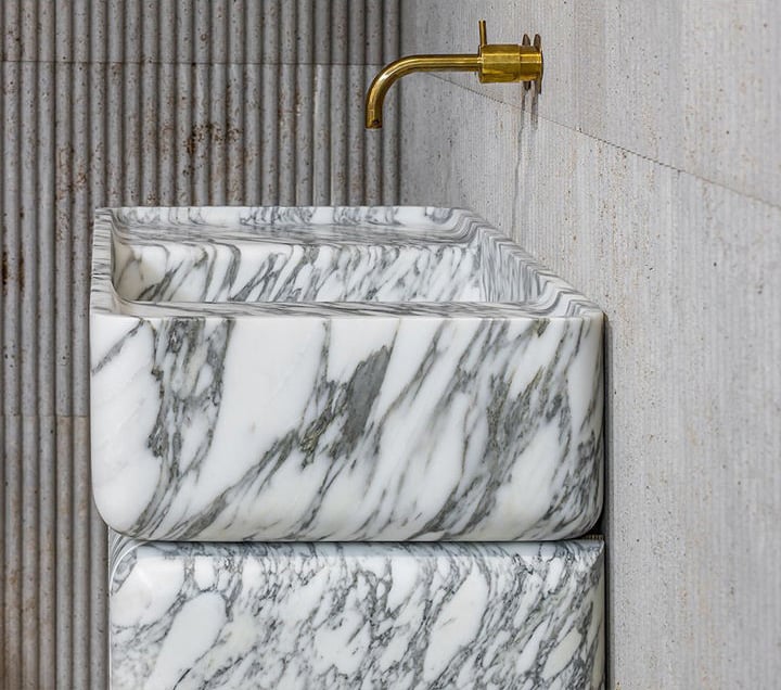 Freestanding marble bathroom vanity unit with Arabescato white marble texture