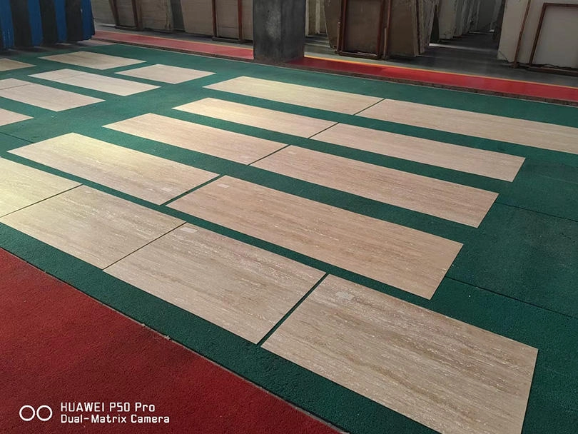 Thin travertine sheets laid out for surface colour and batch inspection