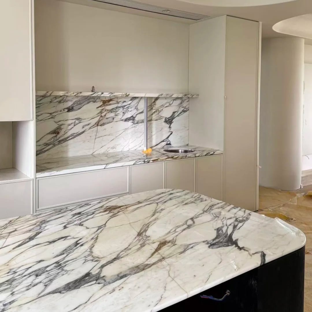 Calacatta Gold Marble luxury interior application with white base and gold grey veining