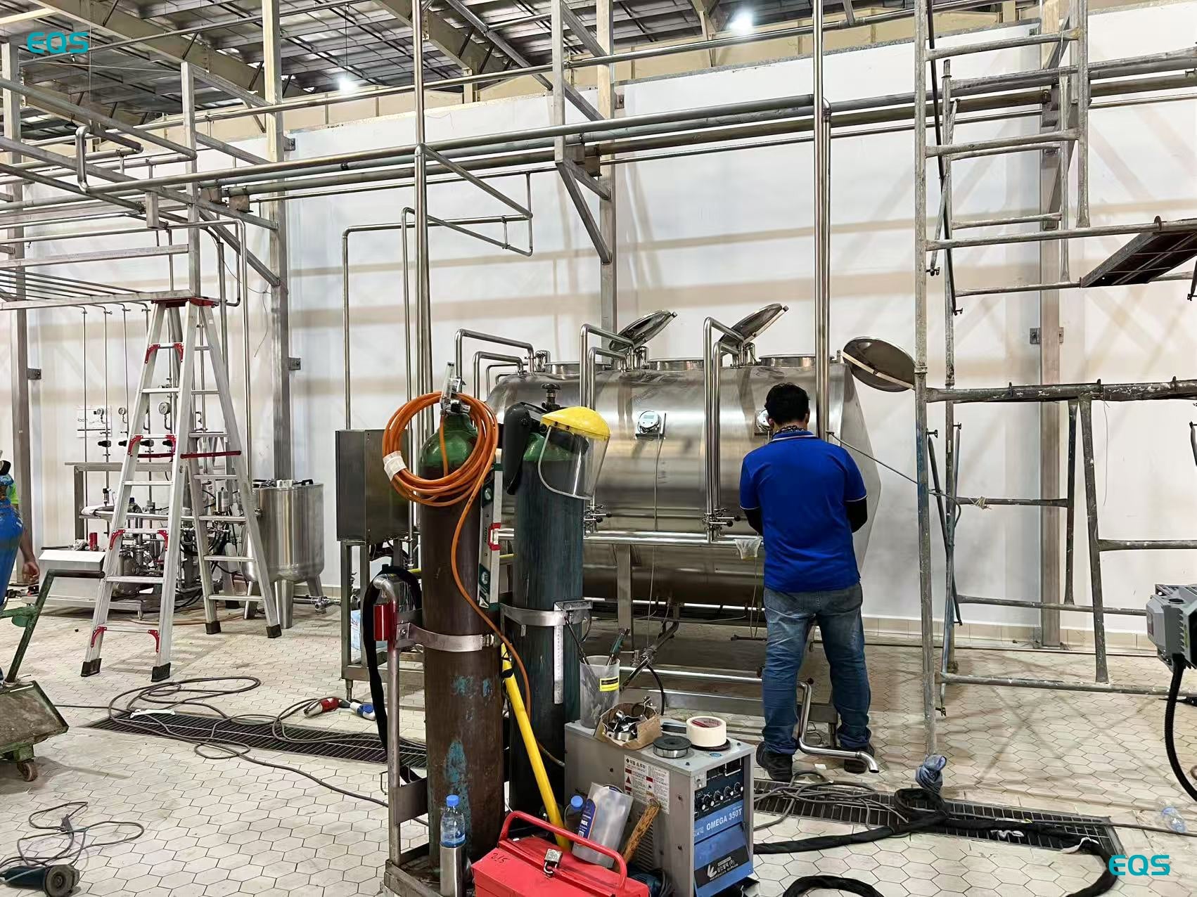 EQS BGF32-32-8 beer bottling line with conveyors installed in a new brewery in Cambodia.jpg