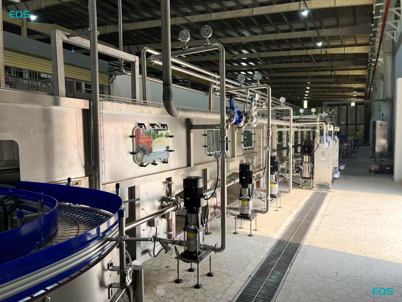 Conveyor and downstream packaging equipment on a 330 ml glass bottle beer bottling line in Cambodia.jpg