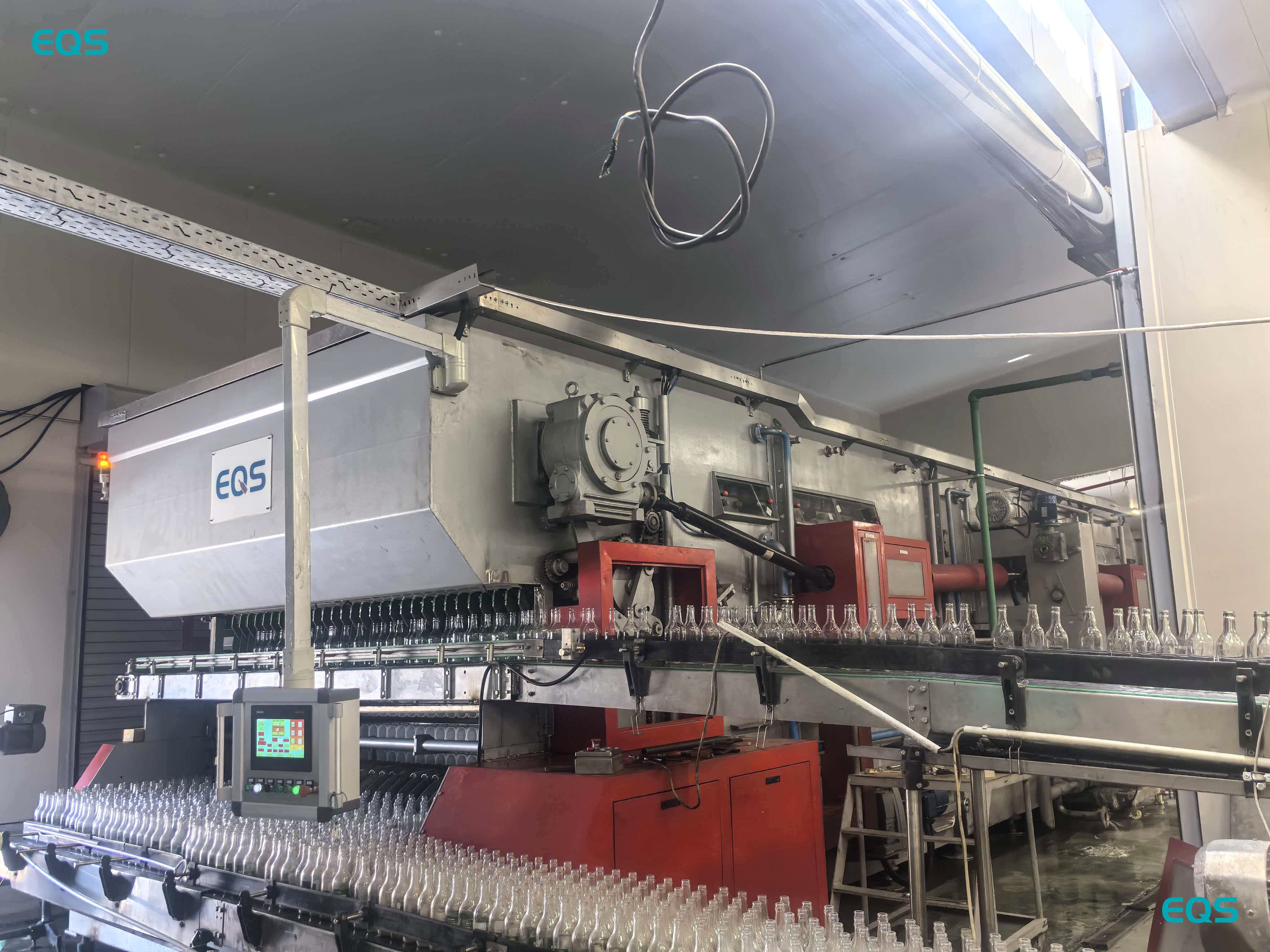 EQS BXP9530 glass bottle washing machine cleaning returnable glass bottles at a plant in Greece.jpg