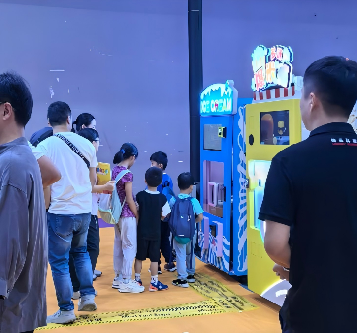 Children lining up before the automatic ice-cream vending machine IC320.png