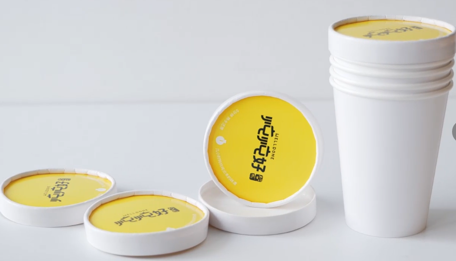 One-piece molded lid with paper cup
